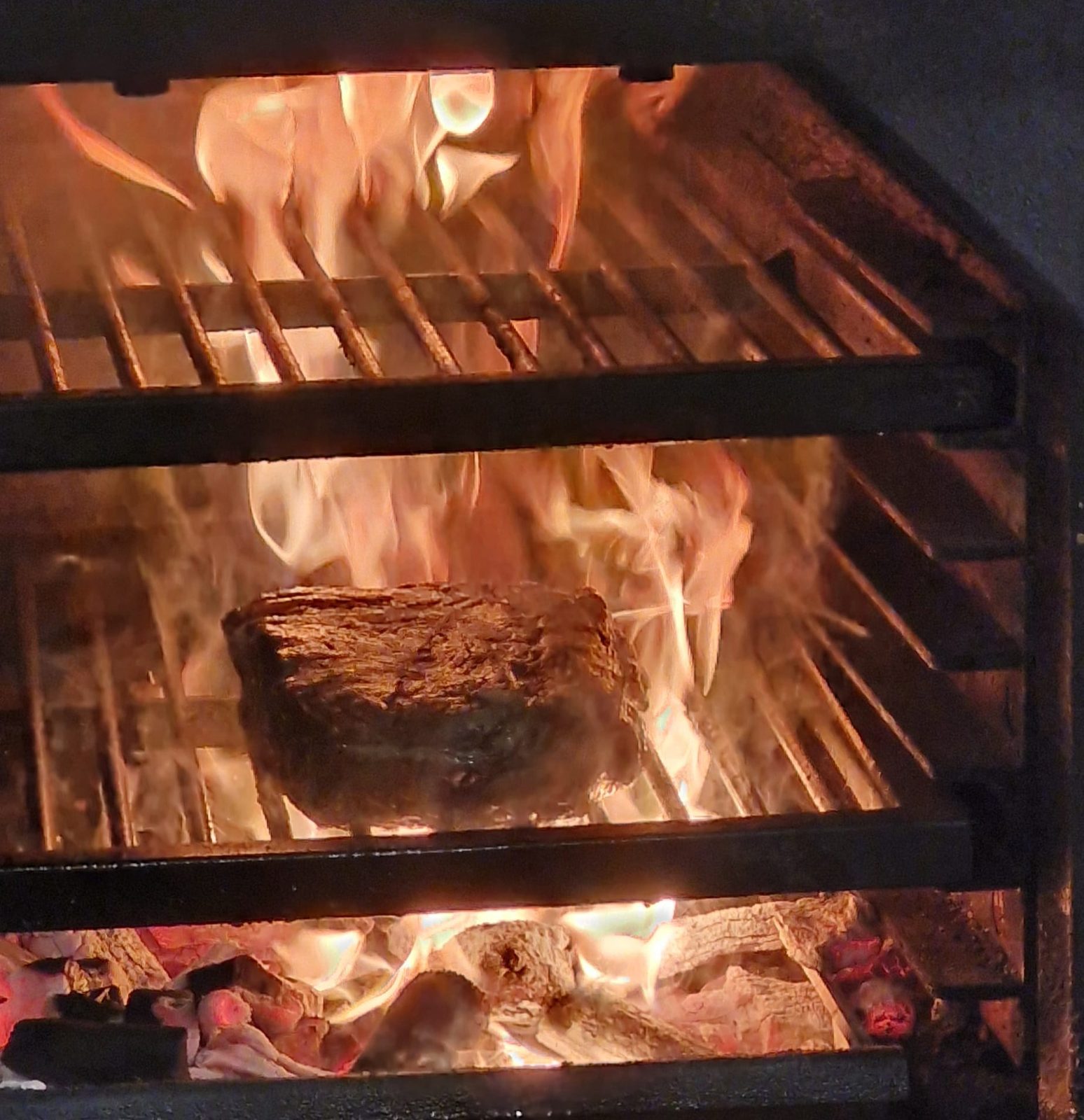 A cut of beef over the embers of the Josper — Chez Bastianin